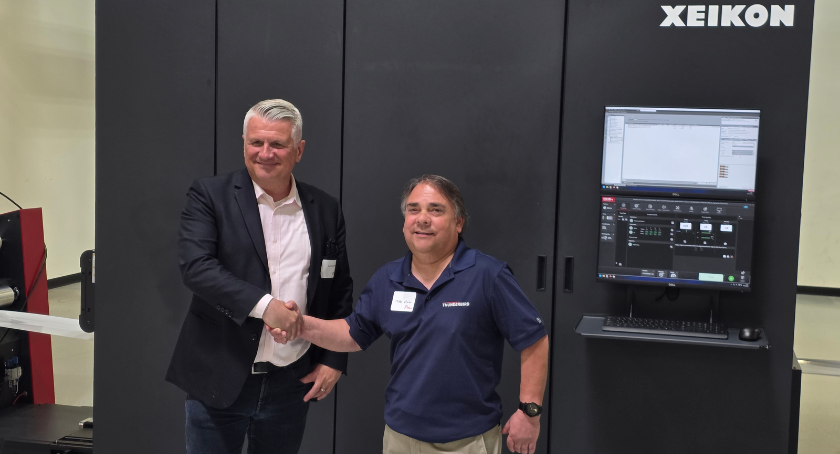 Walter Benz congratulates Mike Vicino of Thunderbird Molding on the first North American install of Ecolyne.